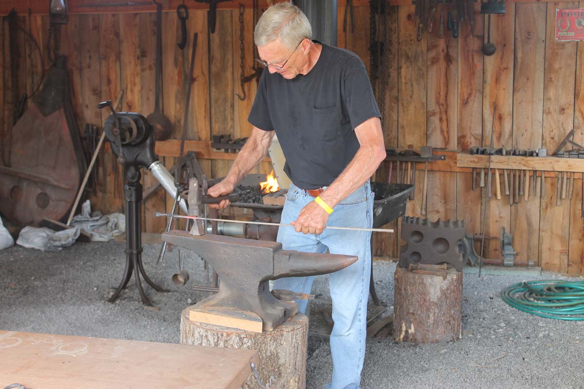 A blacksmithing demonstration at Hallockville Country Fair