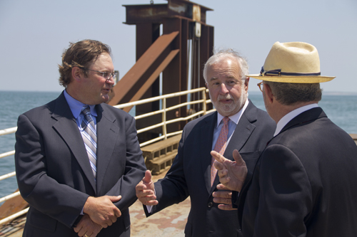 (L-R) Cross Sound Ferry co-owner Adam Wronowski speaks with Congressman Tim Bishop and the ferry's Long Island liason David Kapell near the terminal Tuesday afternoon. (Credit: Paul Squire)