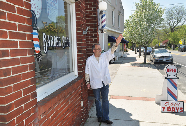 A customer honked his horn as he passed by Al Amore's Tailored Male Barber Shop in Cutchogue earlier this month. (Credit: Grant Parpan)
