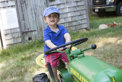 Levi Silverman, 17 months, of Southold rides a tractor kids' corner. (Credit: Katharine Schroeder photos)