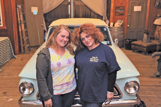 Jessie Siegel (left) and her mother, Marisa Striano, inside the barn at their organization, Spirit's Promise Equine Rescue and Rehabilitation in Baiting Hollow.  (Credit: Krysten Massa)