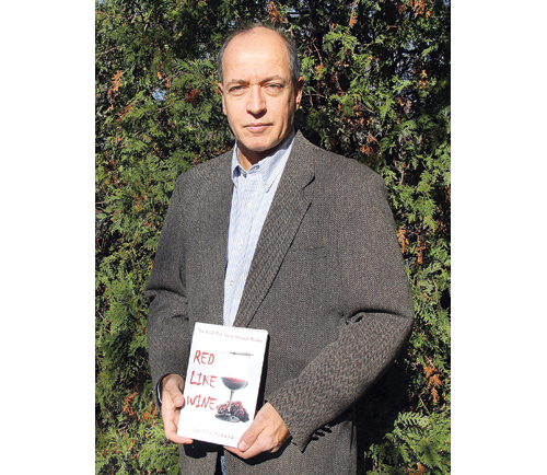 CARRIE MILLER PHOTO | Joseph Finora with his first novel, which takes place in Wine Country.