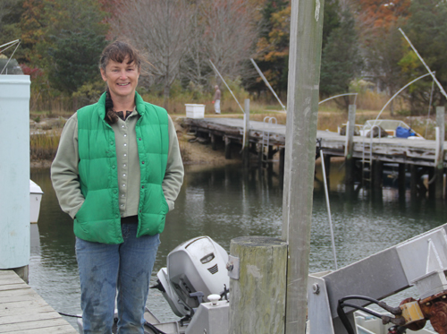 CARRIE MILLER PHOTO | Karen Rivara on the dock at her Southold based oyster business.