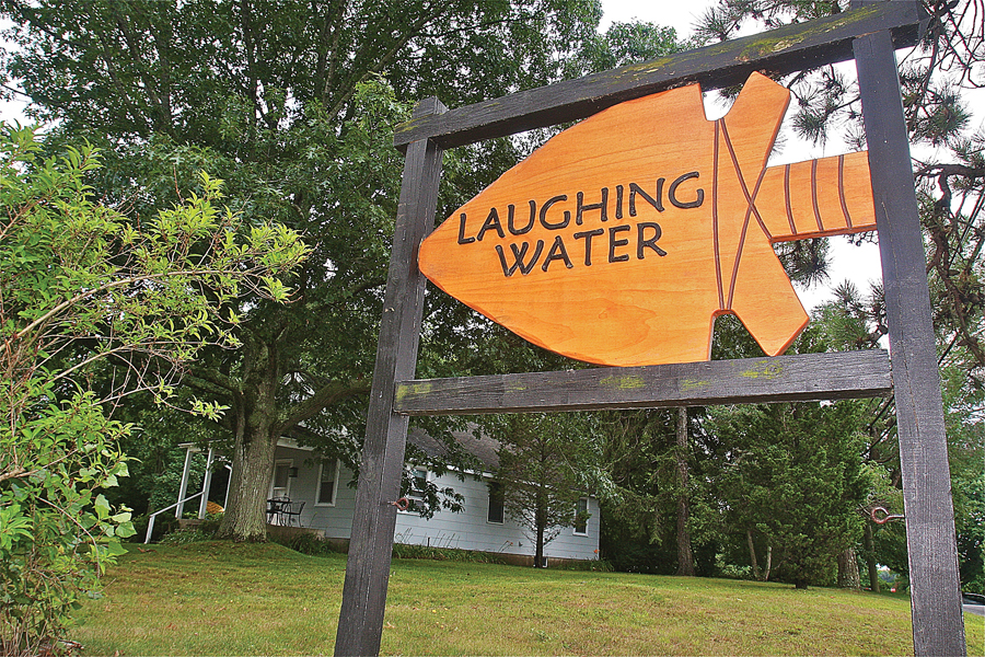 Laughing Waters resident Dennis Gallagher made this wooden sign in 2013. (Credit: Barbaraellen Koch)