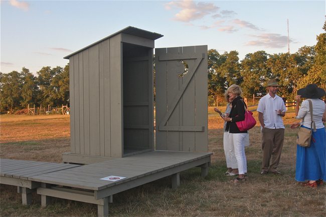 Guests at Hallockville Museum Farm during the opening reception Thursday evening of 'Outhouse 2014' by artist Michael Combs of New York City and Greenport. (Credit: Barbaraellen Koch)