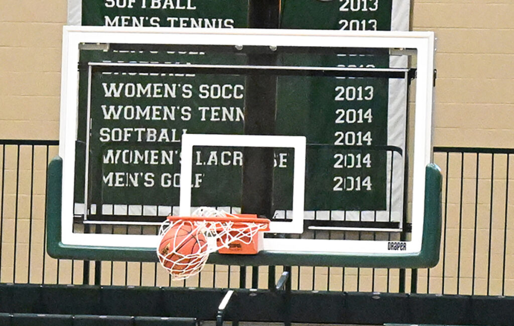 high school sports basketball hoop with basketball swooshing through the net