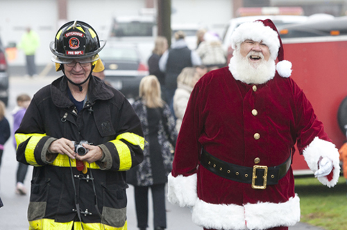 KATHARINE SCHROEDER PHOTO | Santa's greeting by firefighters in Cutchogue.