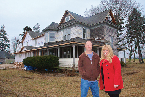 General contractor Roy Schweers and New Beginnings founder Allyson Scerri outside the old farmhouse on Sound Avenue being renovated for Brendan House, a long-term care facility for adults with brain trauma. (Credit: Barbaraellen Koch, file)