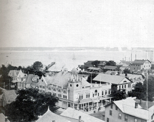 This undated aerial shot of the east side of Greenport Village's commercial district features the Greenport Opera House as the focal point. (Credit: Postcard History Series)