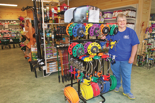 Employee Barbara Zimnoski in the new Long Island Cauliflower showroom, which has a large selection of Dramm professional watering tools, sprinklers and hoses. (Credit: Barbaraellen Koch)