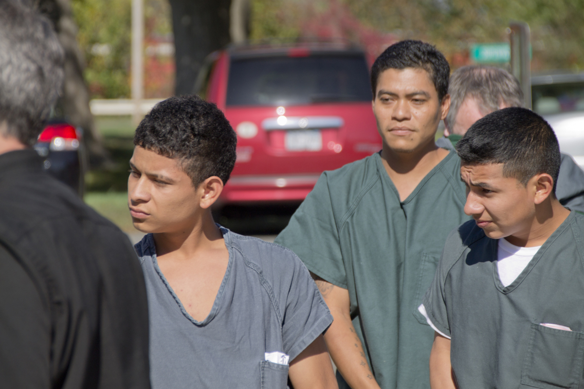 Southold shooting suspects (from left) Walter Vasquez, 17, of Greenport;  Pedro Emilio Santamaria, 31, of Greenport; and Jeremias Nathaniel Recinos Torres, 19, of Aquebogue are escorted by corrections officers into Southold Town Court Friday morning. The three were arraigned in Suffolk County court Wednesday. (Credit: Paul Squire)