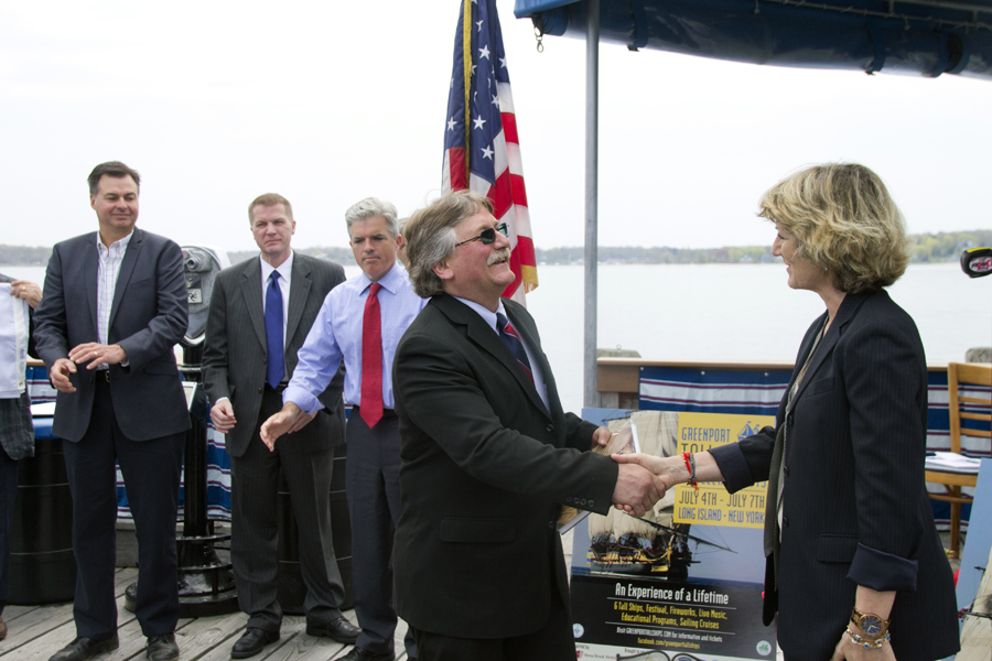 Greenport Mayor George Hubbard shakes hands with Judi Kilachand, executive director of the Friends of Hermione-LaFayette in America. (Credit: Paul Squire)
