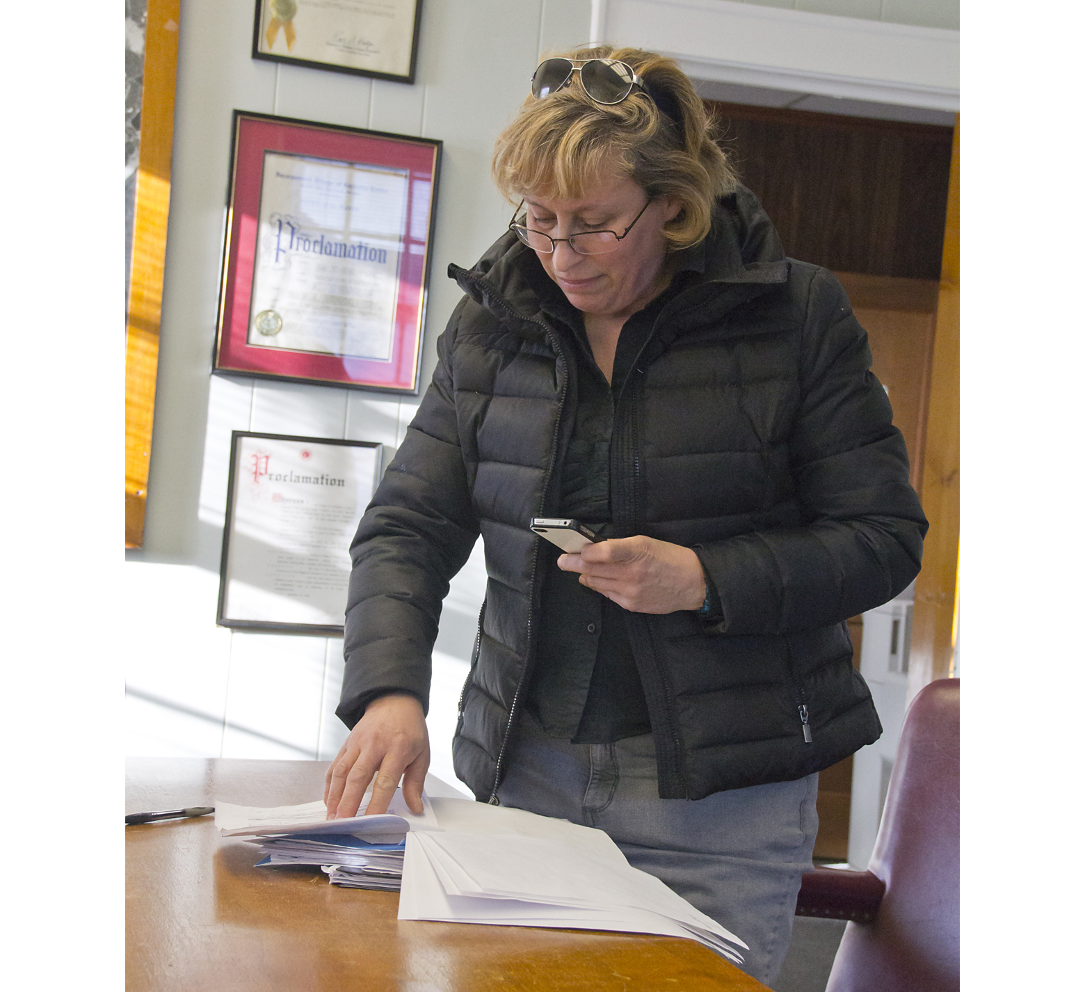Candidate for Greenport Mayor Zuleyha Lillis inspects her opponent George Hubbard's petitions. (Credit: Paul Squire)