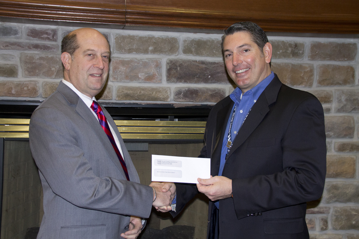Peconic Landing CEO Robert Syron (right) hands over a check for $4,000 to Southold Superintendent David Gamberg last Friday. (Credit: Paul Squire)
