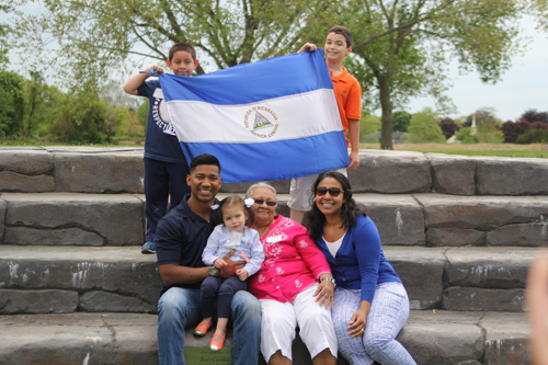 Mr. Castillo, left bottom, with his niece, grandmother Leonor Castillo, sister Dina MacDonald, cousin Tomas Artola (top left) and nephew Cameron MacDonald holding the flag of their native country, Nicaraguan.