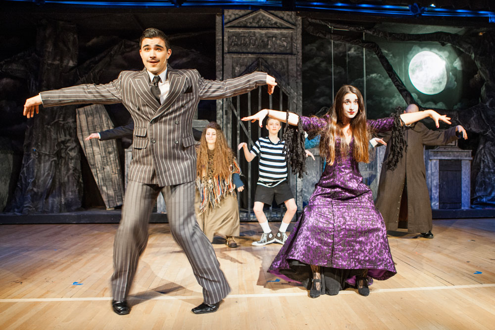 Gomez and Morticia Addams, played by William Tondo and Winter Wilcenski, lead their family members in a song and dance during a rehearsal for 'The Addams Family.' (Credit: Katharine Schroeder)