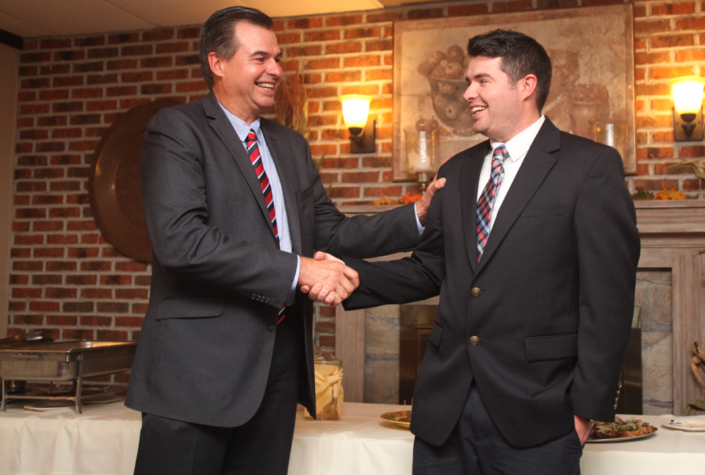 Al, left, and Nick Krupski shake hands before giving their victor speeches at the town Democratic event at Touch of Venice in their hometown of Cutchogue Tuesday. (Credit: Chris Lisinski)