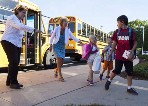 KATHARINE SCHROEDER PHOTO | Students and staff at the morning buses at Cutchogue East Elementary School  on the first day of the 2013-14 school year Monday morning.