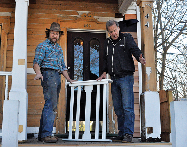 Builder Matthew Ritter (left) discusses placement of a new wooden railing with Bennett Brokaw, who is restoring this 19th-century house on Main Street in Greenport. (Credit: Rachel Young)