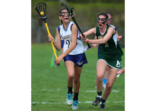Bishop McGann-Mercy's Monica Healy defends against Mattituck/Greenport/Southold's Riley Hoeg, who prepares to take a shot. (Credit: Daniel De Mato)