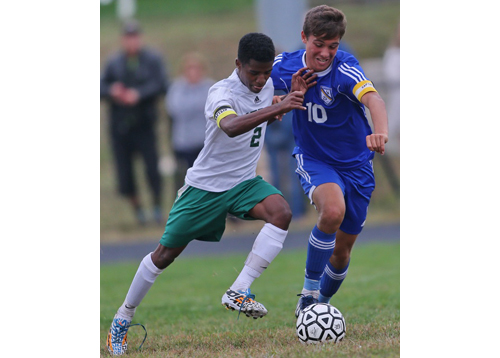 Bishop McGann-Mercy's Bereket Watts, left, and Mattituck's Paul Hayes cross paths during Tuesday's game, which saw 11 goals scored. (Credit: Garret Meade)