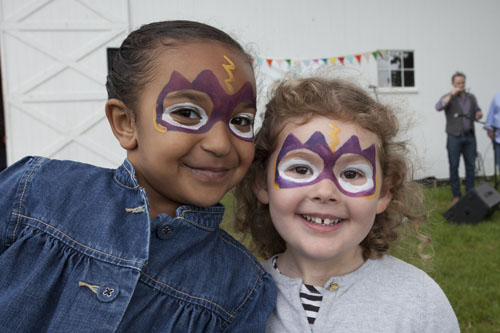 Rylee Owens, 5, of Greenport (left) and Emma Roner, 3, of Riverhead show off their painted faces. (Credit: Katharine Schroeder)