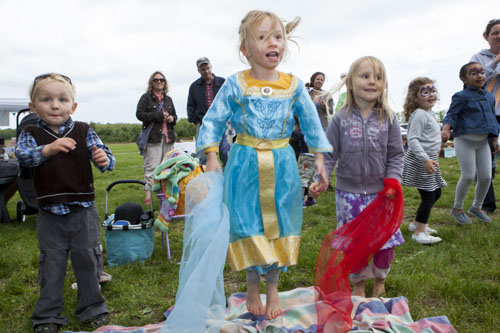 From left: Oliver Faint, 3, of Peconic; Sophie Heidemann, 4, of Southold; and Phoebe Faint, 4, of Peconic dance to the music. (Credit: Katharine Schroeder)