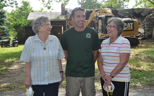 Michael Bredemeyer (center) with his grandmother, Jeanne, (left) and mother, Beverly, standing in front of the demolition.  (Credit: Cyndi Murray)