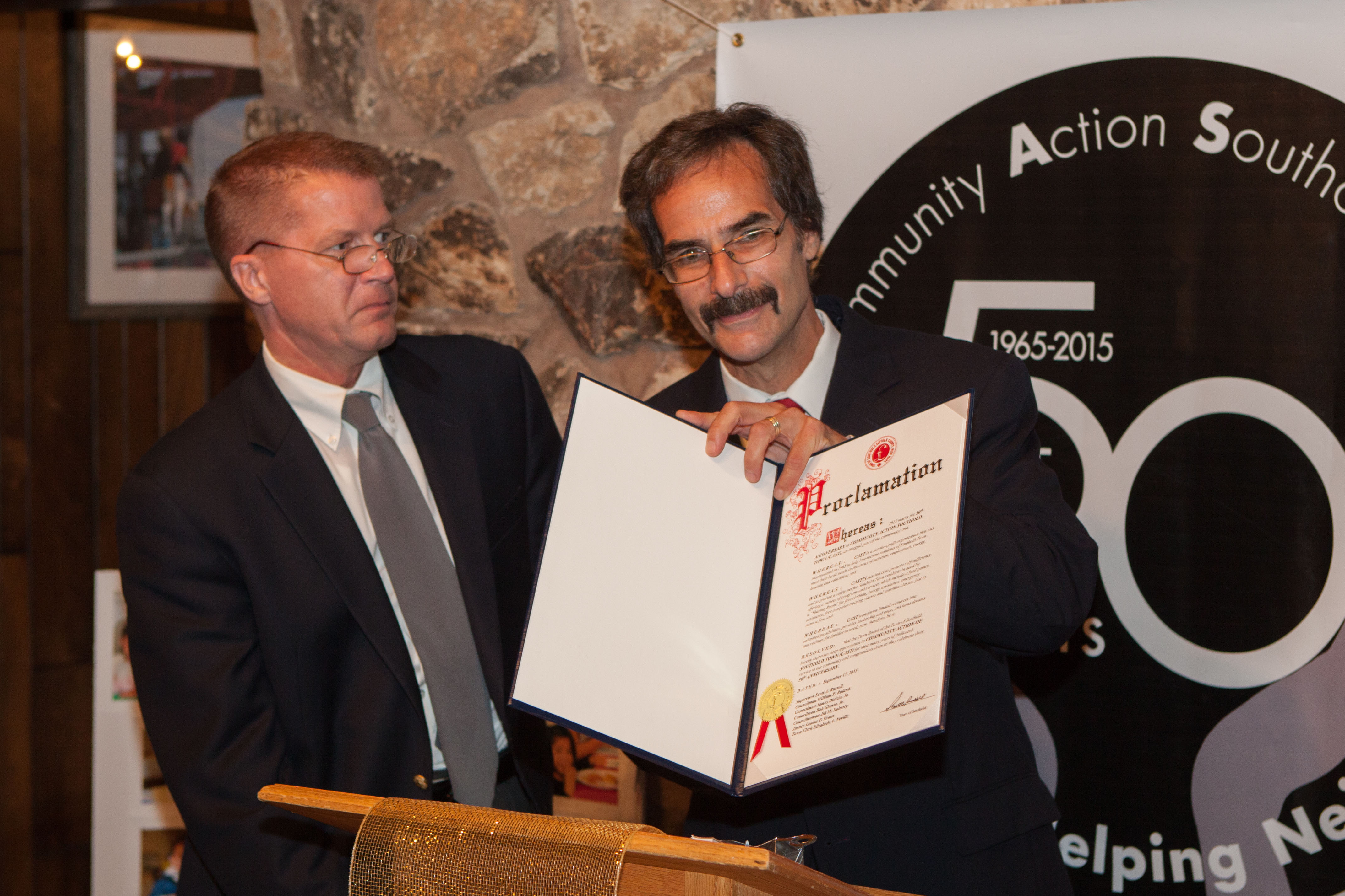 Scott Russell presents Denis Noncarrow with a proclamation honoring CAST's 50th anniversary.