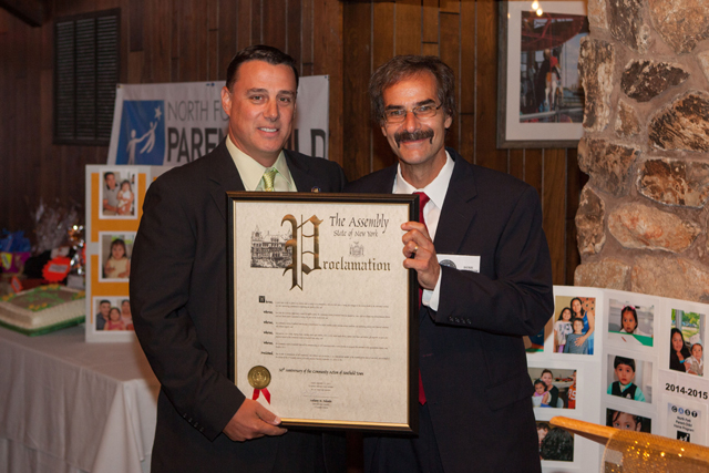 Assemblyman Anthony Palumbo presents Denis Noncarrow with a proclamation honoring the 50th anniversary of CAST. 