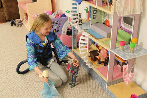 Camryn plays with her dollhouse during her each morning before heading to school.