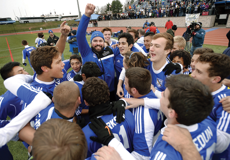 The Mattituck boys soccer team celebrates its state title. (Credit: Adrian Kraus)