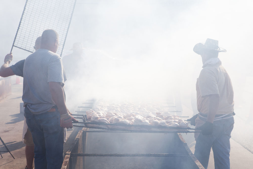Volunteers are obscured by the chicken smoke. (Credit: Katharine Schroeder)