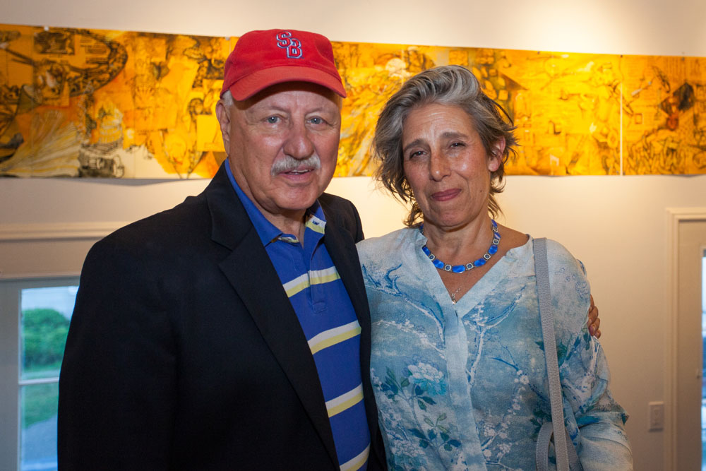 Senator Ken LaValle with artist Ellen Wiener. Her artwork can be seen in the background. (Credit: Katharine Schroeder)