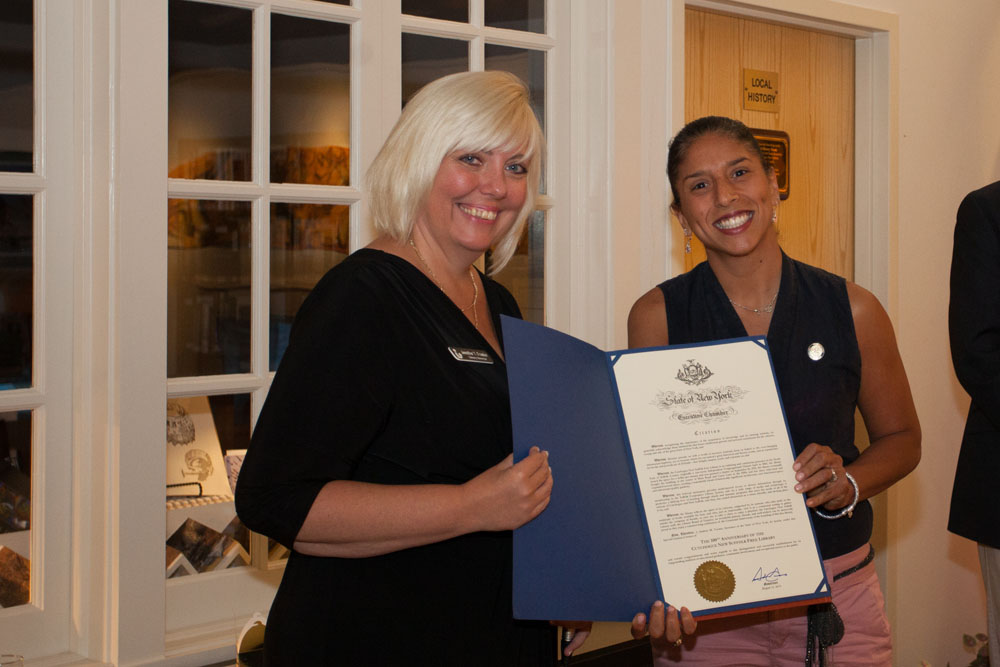 Vanessa Pino Lockel, Suffolk County Representative to Governor Cuomo, presents a proclamation sent by the governor. (Credit: Katharine Schroeder)