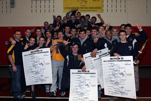 The Mattituck HS Wrestling team celebrates its second Suffolk County Championship in a row. The Suffolk County Division II wrestling championships were held at  Center Moriches High School on Feb. 15, 2014. (Photo credit: Daniel DeMato)