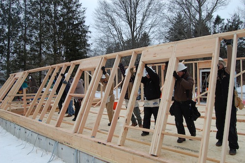 Volunteers help erect the home's back wall. (Credit: Cyndi Murray)