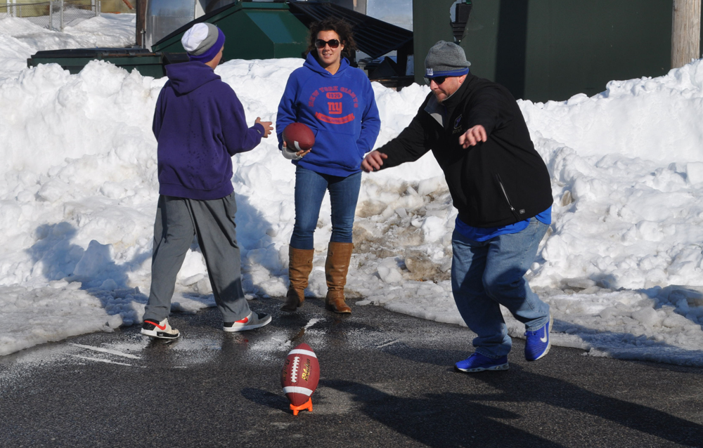 Chris Doucett tries a 50-yard field goal for fun after already winning the contest. His son Sean, left, also converted a pair of field goals and showed off his arm at times too. He's a quarterback at Greenport.