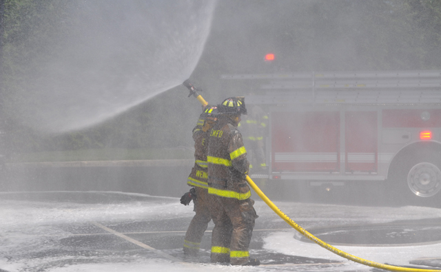 Southold, Cutchogue and East Marion fire department volunteers hosed down Southold's two new trucks and each other Sunday afternoon. (Credit: Grant Parpan)
