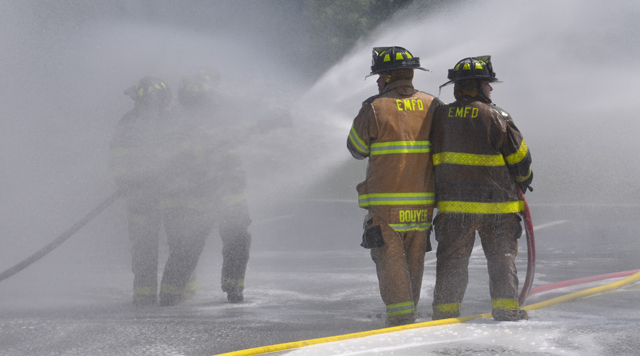 Southold, Cutchogue and East Marion fire department volunteers hosed down Southold's two new trucks and each other Sunday afternoon. (Credit: Grant Parpan)