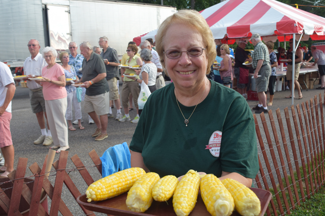 Dorothy Bakowski of Cutchogue serves up some corn. (Credit: Vera Chinese)