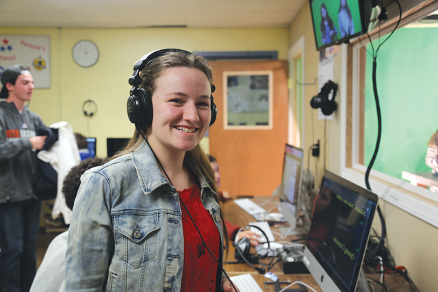 Southold senior Daisy Rymer during class last Thursday. As co-producer, she talks to the anchors through a headset, sets up equipment for filming and edits the news show. (Credit: Krysten Massa)