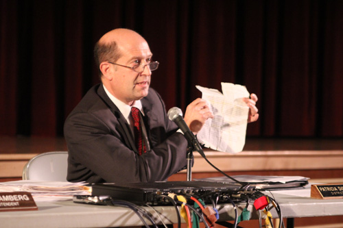 JENNIFER GUSTAVSON PHOTO | Southold School District Superintendent David Gamberg holding an article he's carried around since 2010 that reminds him why the district didn't take Race to the Top funds.