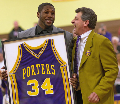 GARRET MEADE PHOTO | Ryan Creighton, holding his retired No. 34 jersey, sharing a laugh with the Greenport school superintendent, Michael Comanda.
