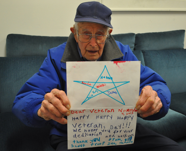 Fred Carter of Cutchogue holds up a handmade card he received from a group of local Girl Scouts.