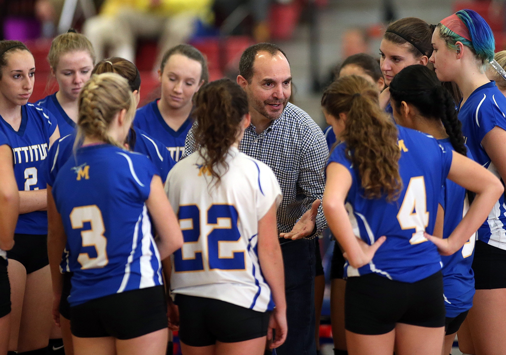 Coach Frank Massa talks to his team during a stoppage in play.
