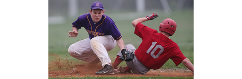 Southold's Dylan Clausen slides into third base safely while Greenport's Keegan Syron covers the bag. (Credit: Garret Meade)
