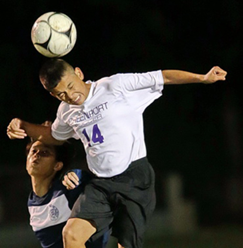Greenport's Cristian Lopez rises above Stony Brook's Jong Hyun Choi to head the ball during Friday night's game. (Credit: Garret Meade)