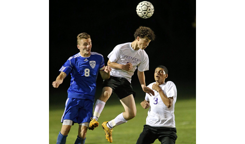 From left, Smithtown Christian's Timothy Voisich and Greenport's Robert Nickolas and Angel Colon in action during Friday night's game. {Credit: Garret Meade)