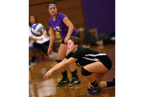 Greenport/Southold's libero, Sam Henry, attempts a dig while teammate Jenna Standish watches. (Credit: Garret Meade)